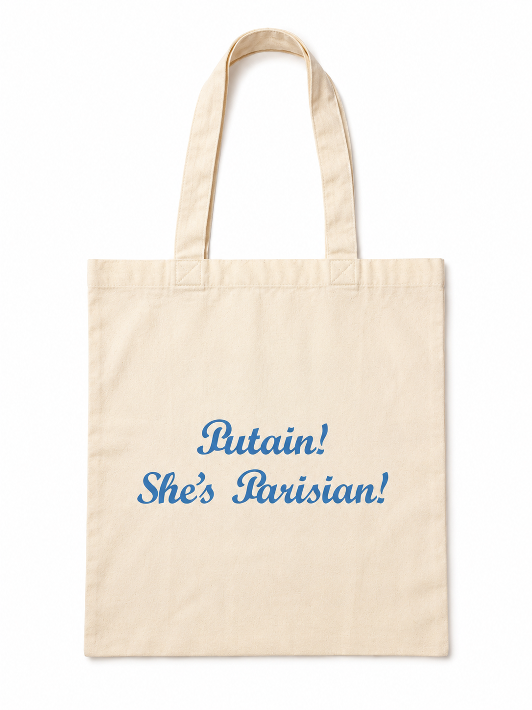Beige tote bag with blue text 'Putain! She's Parisian!' on a white background